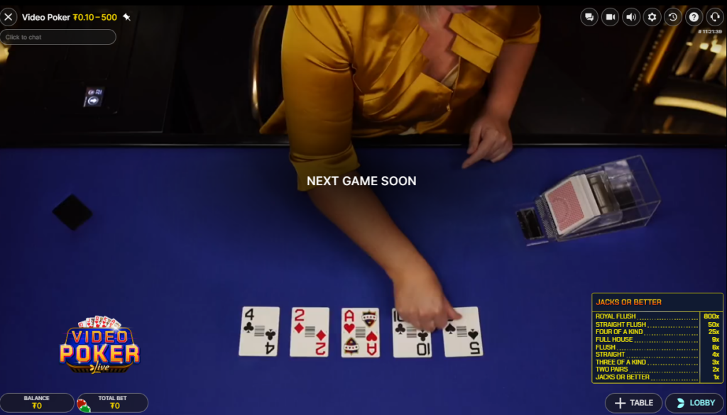 A dealer puts cards out during a CoinPoker live Jacks or Better game.